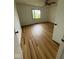 This bedroom features new wood flooring, a ceiling fan, and a window letting in natural light at 1925 W State Road 32, Lebanon, IN 46052