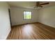This bedroom features new wood flooring, a ceiling fan, and a window letting in natural light at 1925 W State Road 32, Lebanon, IN 46052