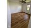 This bedroom features new wood flooring, a ceiling fan, and a window letting in natural light at 1925 W State Road 32, Lebanon, IN 46052