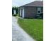 Two-car garage with brick exterior and gravel driveway, next to a lush green lawn at 1925 W State Road 32, Lebanon, IN 46052