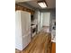 Kitchen area showcasing wood cabinets, white appliances, and modern flooring at 1925 W State Road 32, Lebanon, IN 46052