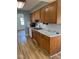 Kitchen featuring oak cabinets, marble countertops, stainless steel sink, and modern hardwood flooring at 1925 W State Road 32, Lebanon, IN 46052