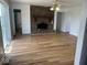 Bright living room featuring hardwood floors, a brick fireplace, and a sliding glass door at 1925 W State Road 32, Lebanon, IN 46052