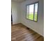 Bright living room with beautiful wood-look floors and view of green space through window at 1925 W State Road 32, Lebanon, IN 46052