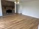 Spacious living room featuring hardwood floors, a brick fireplace, and neutral paint colors at 1925 W State Road 32, Lebanon, IN 46052