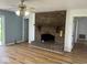 Living room featuring hardwood floors, brick fireplace, and neutral paint colors at 1925 W State Road 32, Lebanon, IN 46052
