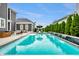 Stunning backyard pool with a waterfall feature, surrounded by lush landscaping at 2037 Stanhope St, Carmel, IN 46032