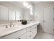 This bathroom includes double sinks, white cabinets, quartz counters, and tile floors at 2037 Stanhope St, Carmel, IN 46032