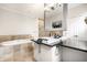 Modern bathroom with a white vanity, tub with tan tile surround, and a walk-in closet at 2037 Stanhope St, Carmel, IN 46032
