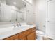 The bathroom includes a wood vanity, white countertop, and frosted glass shower at 2037 Stanhope St, Carmel, IN 46032