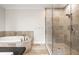 This bathroom showcases a soaking tub, tiled shower, and neutral color palette at 2037 Stanhope St, Carmel, IN 46032