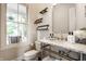 Charming powder room features updated fixtures, natural light, and stylish shelves at 2037 Stanhope St, Carmel, IN 46032