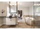 This bathroom features a large vanity, soaking tub, walk-in closet, and travertine floors at 2037 Stanhope St, Carmel, IN 46032