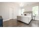 This bedroom features a plush bed, hardwood floors, chandelier and lots of natural light at 2037 Stanhope St, Carmel, IN 46032