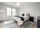 Bedroom with hardwood floors, neutral walls, window, chandelier, and black and white rug at 2037 Stanhope St, Carmel, IN 46032