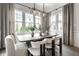 Dining area with natural light showcases a modern table, comfortable seating and stylish light fixture at 2037 Stanhope St, Carmel, IN 46032