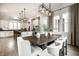 Open concept kitchen and dining space with an island, white cabinets and a dark wood dining table at 2037 Stanhope St, Carmel, IN 46032