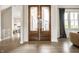 Grand entryway with wood floors and double glass doors leading to a bright space at 2037 Stanhope St, Carmel, IN 46032