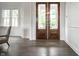 Elegant entryway featuring gleaming hardwood floors and double-door access to the porch at 2037 Stanhope St, Carmel, IN 46032