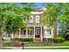 Lovely two-story home with a welcoming front porch, brick facade, lush landscaping, and a well-maintained lawn at 2037 Stanhope St, Carmel, IN 46032