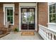 Inviting front entrance featuring a double-door entry, classic brickwork, and a welcoming doormat at 2037 Stanhope St, Carmel, IN 46032