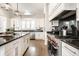 Bright kitchen features white cabinets, stainless appliances, and dark countertops with a white brick backsplash at 2037 Stanhope St, Carmel, IN 46032