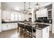 Gourmet kitchen with white cabinets, a large center island, and modern stainless steel appliances at 2037 Stanhope St, Carmel, IN 46032