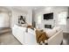 Bright living room showcases a fireplace, tv and white sectional providing an elegant space for relaxation at 2037 Stanhope St, Carmel, IN 46032