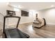 Bright living room with light-colored floors, sofa, and a large TV at 2037 Stanhope St, Carmel, IN 46032