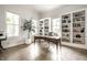 Bright home office with custom built-ins, large windows, and hardwood flooring at 2037 Stanhope St, Carmel, IN 46032