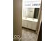 This bathroom includes a double sink, vanity, tiled floor and ample lighting at 3016 Wildcat Ln, Indianapolis, IN 46203