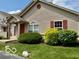 Exterior view of home with well-manicured lawn, shrubs, and neutral siding at 3016 Wildcat Ln, Indianapolis, IN 46203
