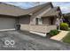 Property exterior featuring attached garage, trash receptacles, and concrete driveway at 3016 Wildcat Ln, Indianapolis, IN 46203
