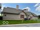 Angle view of the home's exterior with well-kept lawn and neutral-colored siding at 3016 Wildcat Ln, Indianapolis, IN 46203