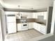 Bright kitchen features white cabinets, appliances, and neutral countertops, offering a clean and functional space at 3016 Wildcat Ln, Indianapolis, IN 46203