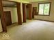 Bedroom featuring natural light, multiple closets, and neutral carpet at 310 S Shady Ln, Muncie, IN 47304