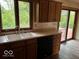 Kitchen with sliding door to deck, light countertops, and a double basin sink at 310 S Shady Ln, Muncie, IN 47304
