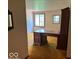 Office featuring a wooden desk, a window, and gold carpeting at 310 S Shady Ln, Muncie, IN 47304