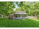 Backyard view featuring a spacious deck and lush lawn, perfect for outdoor entertaining at 3333 Melbourne S Rd, Indianapolis, IN 46228