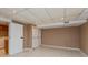 Finished basement area with tile flooring, storage closets, and neutral colored walls at 3333 Melbourne S Rd, Indianapolis, IN 46228