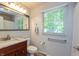 Updated bathroom with wood vanity, marble countertop, and natural light at 3333 Melbourne S Rd, Indianapolis, IN 46228