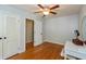 Bedroom featuring hardwood floors, ceiling fan and trim, complemented by ample closet space at 3333 Melbourne S Rd, Indianapolis, IN 46228