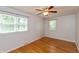 Sunlit bedroom with hardwood floors and large windows offering a view of the outdoors at 3333 Melbourne S Rd, Indianapolis, IN 46228