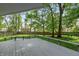 Covered deck overlooking a lush backyard providing shade and relaxation for outdoor enjoyment at 3333 Melbourne S Rd, Indianapolis, IN 46228