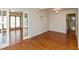 Spacious dining room with hardwood floors and open doorway to living area at 3333 Melbourne S Rd, Indianapolis, IN 46228