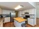 Contemporary kitchen featuring granite countertops, white cabinets, stainless appliances, and a butcher block island at 3333 Melbourne S Rd, Indianapolis, IN 46228