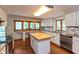 Bright kitchen features granite counters, white cabinetry, and an island with a butcher block countertop at 3333 Melbourne S Rd, Indianapolis, IN 46228