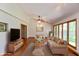 Bright open concept living room featuring hardwood floors, large windows, and modern furnishings at 3333 Melbourne S Rd, Indianapolis, IN 46228
