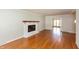 Bright living room showcasing a white brick fireplace and gleaming hardwood floors at 3333 Melbourne S Rd, Indianapolis, IN 46228