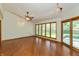 Spacious living room with hardwood floors, large windows, and sliding door access to the outdoor deck at 3333 Melbourne S Rd, Indianapolis, IN 46228
